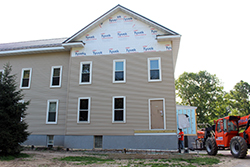 Building with partially installed siding