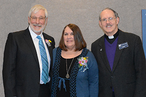 Art Roche poses with his wife Diane and DWC college president, Fr. Tom Ascheman, SVD