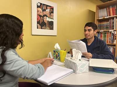 Angel Rodriguez Fuentes tutors an immigrant at the Lantern Center in Dubuque